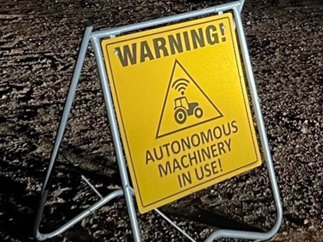 Warning sign on vineyard access path during night-time operation