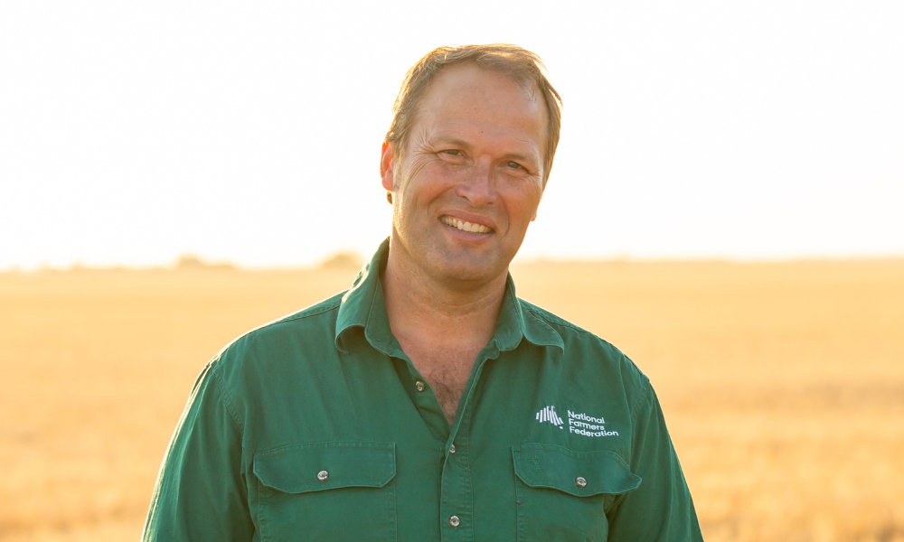 Photo portrait of David Jochinke in a green National Farmers Federation shirt.