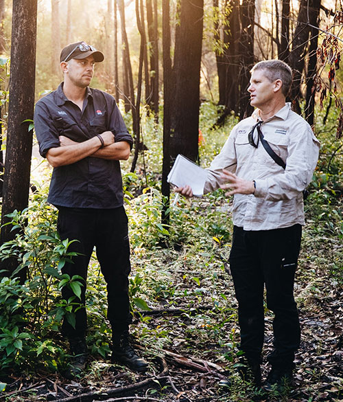 Photo of Dr Geoff Pegg and Aj Perkins in a forest.