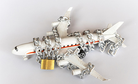 Image of a toy aircraft wrapped in a chain and padlocked