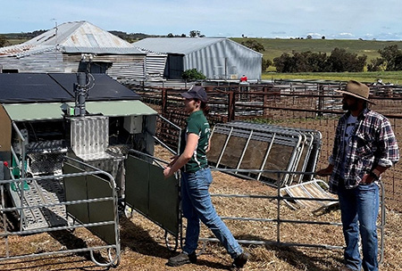 Two people standing outdoors working on the methane measuring project