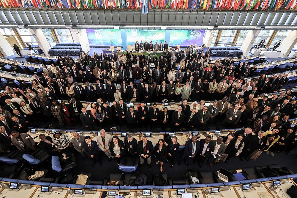 Image taken from a high vantage point in a large room, full of delegates 