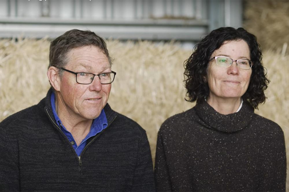 Photo of cattle farmers Ian and Julie Firth in a hay shed