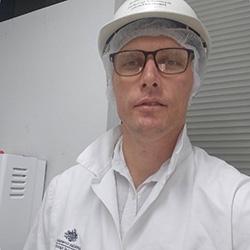 Image of a person in white clothing and a hard hat