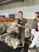 Chris Rodwell holding a sheep fleese